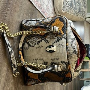 Snake print genuine leather bag.